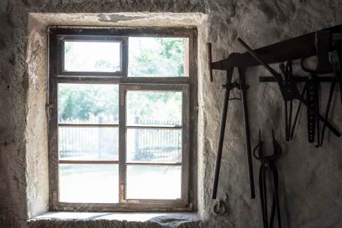 Old rustic window and blacksmith tools Stock Photos