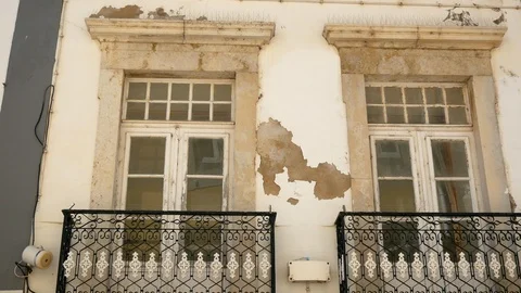 Old rustic window balconies on traditional Portuguese buildings in Algarve Stock Footage 95449715