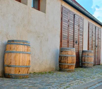 Old rustic wine barrels in front of modern wine cellar. Wine background in Stock-Fotos