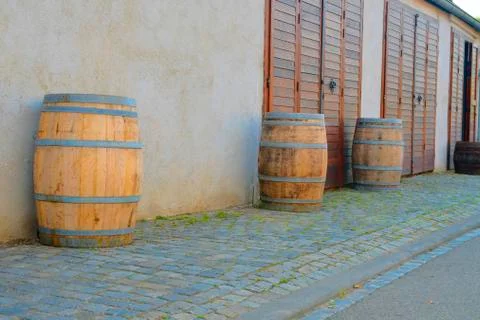 Old rustic wine barrels in front of modern wine cellar. Wine background in Stock-Fotos