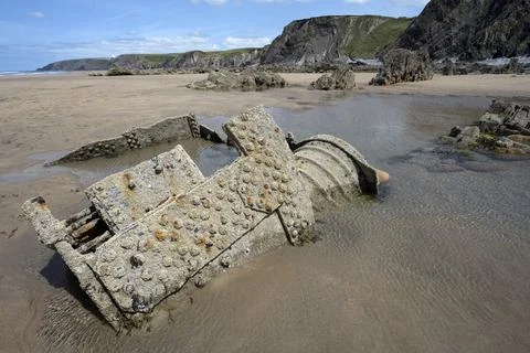 Old rusting shipwreck on Cornwall beach Stock Photos
