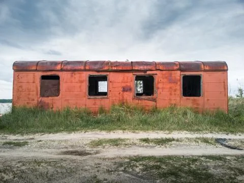 Old rusty abandoned wagon on a cloudy day. Stock Photos