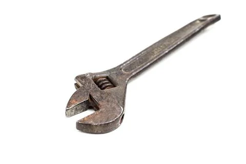 Old rusty adjustable spanner on a white background is isolated Stock Photos
