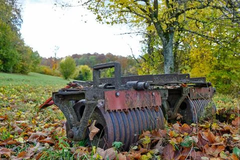 Old rusty agricultural implement in the shape of a field roller Stock Photos