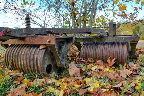 Old rusty agricultural implement in the shape of a field roller Stock Photos