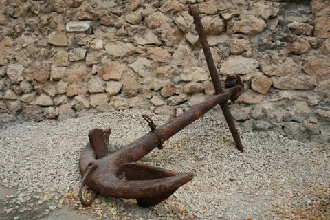 Old rusty anchor on the ground Stock Photos
