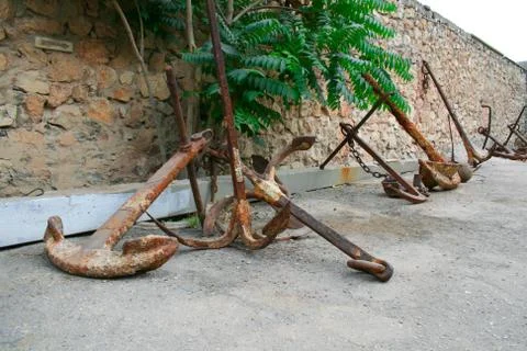 Old rusty anchor on the ground Stock Photos