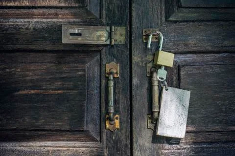 Old rusty and key locks on wooden door Stock Photos