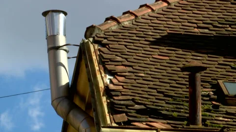 An old rusty and a new shiny metal chimneys in timelapse Stock Footage 55868931