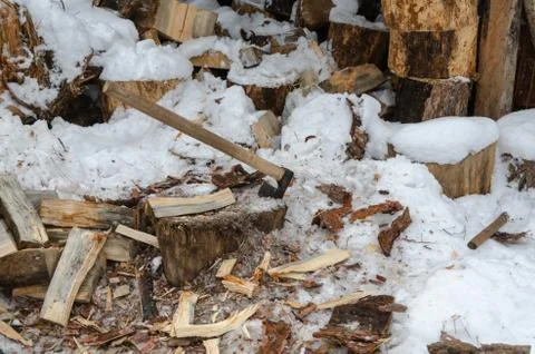 Old rusty ax stuck in a dry wooden log Stock Photos