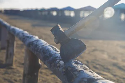 Old rusty ax stuck in a log Stock Photos