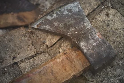 Old rusty axe lies on stone tool logger horizontal macro photo Stock Photos
