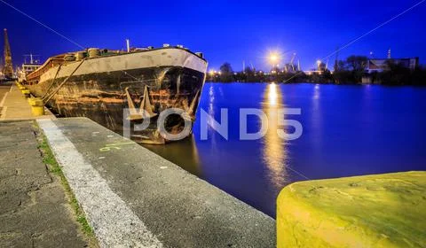 Old rusty barge at night Stock Photos