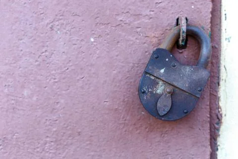 An old rusty barn lock on an iron door Stock Photos