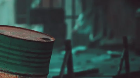 Old rusty barrel in a workshop with tools and machinery in the background Stock Footage 345063011