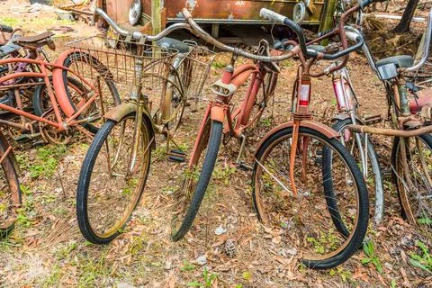 Old rusty bicycles outside closeup Stock Photos