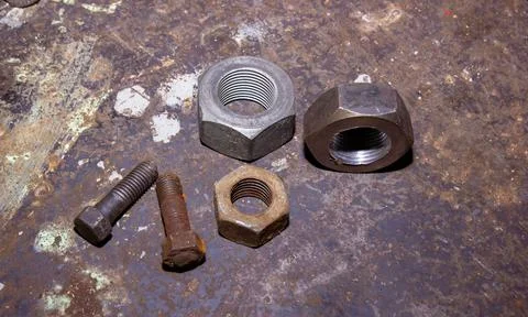 Old rusty bolt and nut on steel background Stock Photos