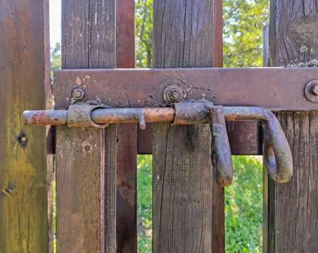 Old rusty bolt bolt latch on the fence Stock Photos