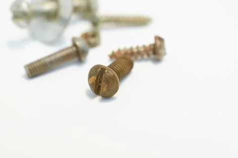 Old rusty bolts, nuts and screws lie on gray background Stock Photos
