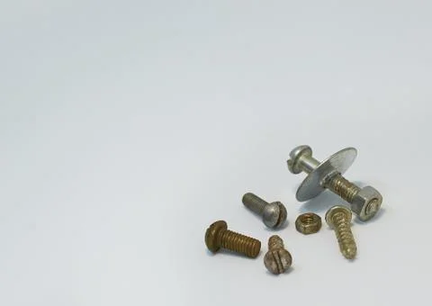 Old rusty bolts, nuts and screws lie on gray background Stock Photos