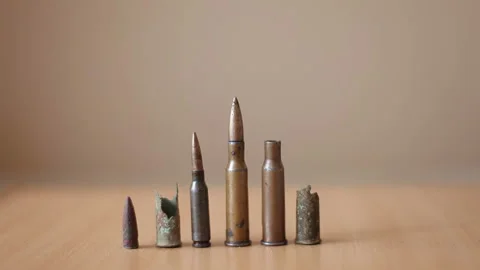 Old rusty bullets and cartridge cases from a machine gun lie on the table Stock Footage 234445555