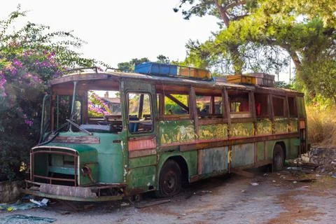 Old rusty bus partly collapsed in salvage yard Stock Photos