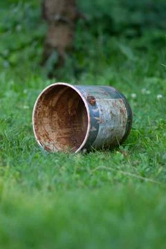 Old Rusty Can Lying On Green Grass Stock Photos