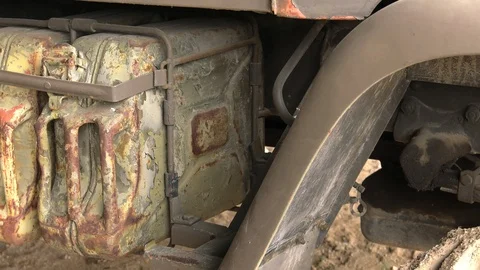 Old rusty canisters are mounted on a military vehicle. Stock Footage 122984643