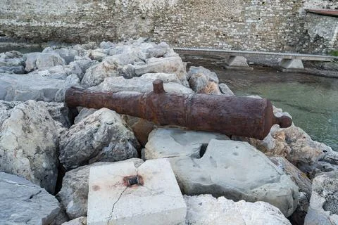 Old rusty cannon embedded in an artificial stone cliff near Methoni Castle Photos