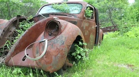 Old rusty car abandoned on side of the road Stock Footage 24614812