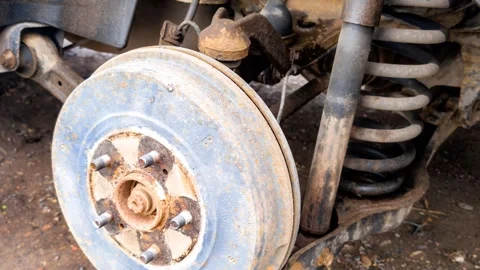 Old rusty car brake drum and suspension system Stock Footage 348237669
