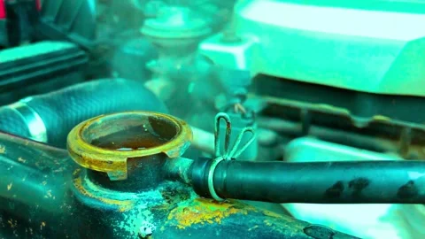 Old rusty car radiator with open cap releasing steam showing engine problems Stock-Footage 342905503