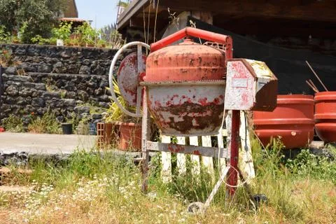 Old rusty cement mixer on construction site Stock Photos