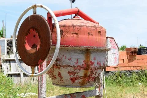 Old rusty cement mixer on construction site Stock Photos