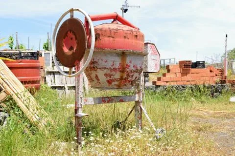 Old rusty cement mixer on construction site Stock Photos