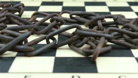 Old rusty chain on a chessboard Stock Footage 78836888