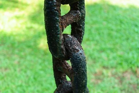 An old rusty chain hangs vertically Stock Photos