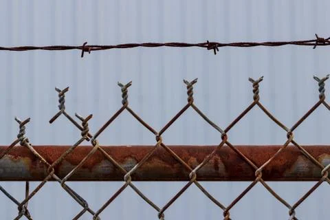 Old rusty chain link barbed wire fence Stock Photos