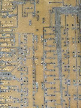 An old rusty computer board with a close-up soldering. Stock Photos
