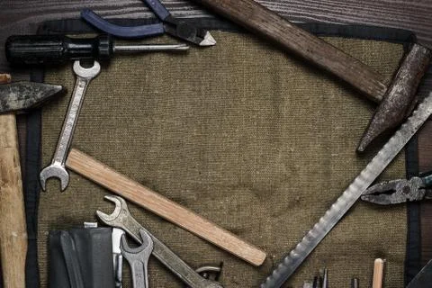 Old rusty construction instruments over wooden background Stock Photos