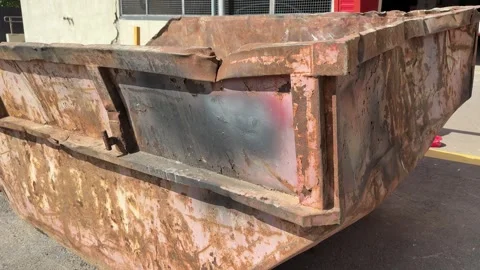 An old rusty container stands motionless in a field overgrown with tall grass Stock-Footage 316388356