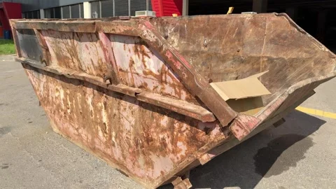 An old rusty container stands motionless in a field overgrown with tall grass Vidéo 316388705