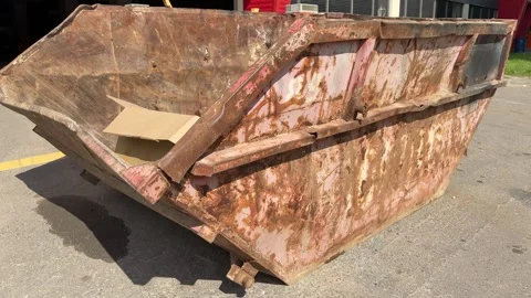 An old rusty container stands motionless in a field overgrown with tall grass Stock Footage 316389086