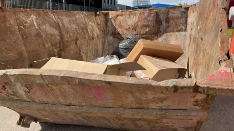 An old rusty container stands motionless in a field overgrown with tall grass Stock Footage 316389450