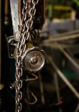 Old rusty control equipment, old rusty valve with chains hanging from it can Stock Photos