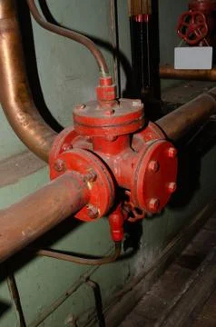Old rusty control equipment, the old red valve can serve as a relic Stock Photos