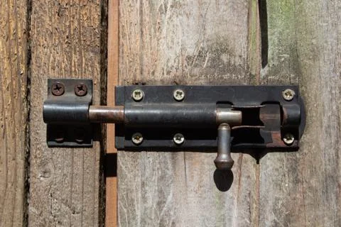 Old rusty door latch on the background of old boards Stock Photos