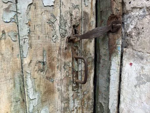 Old rusty door lock on an old wooden door with peeling blue paint Stock Photos