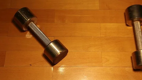 Old rusty dumbbell parquet background hd footage Stock Footage 119167434