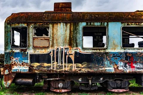 Old rusty electric multiple units abandoned on unused railway tracks Stock Photos